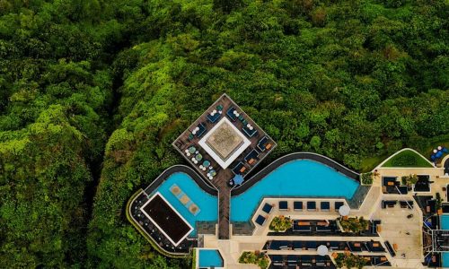 pexels-photo-14150566-14150566 Stunning aerial shot of a luxury resort in Bali, surrounded by lush greenery and ocean view.